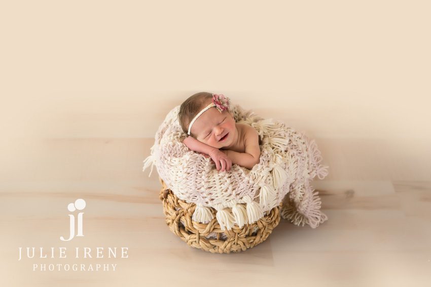 smiling newborn in a basket