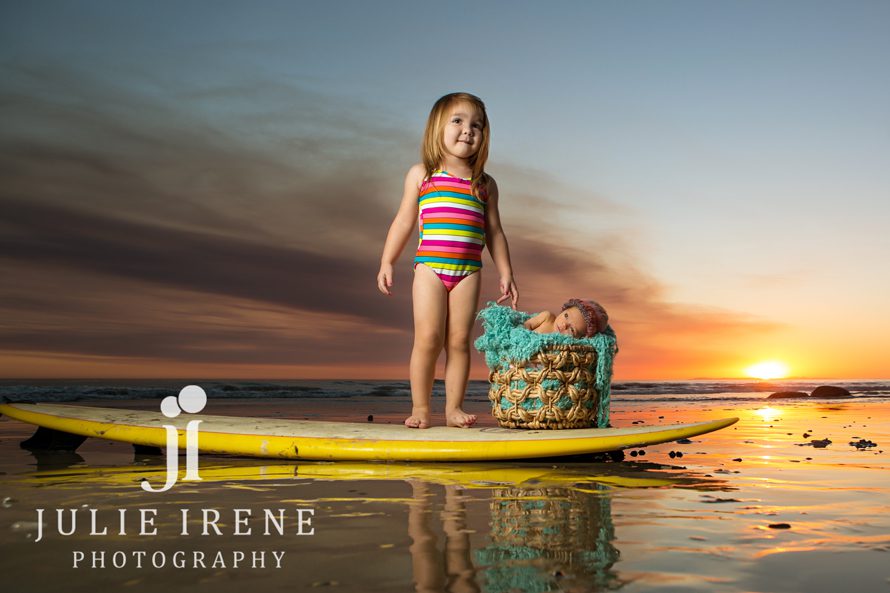 sisters sunset outdoor surfboard newborn baby photography