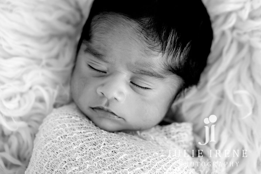 sleeping newborn baby boy in black and white