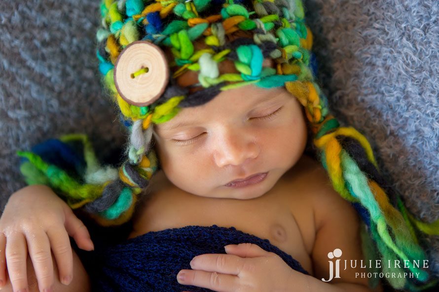 Bright hat sleeping newborn boy