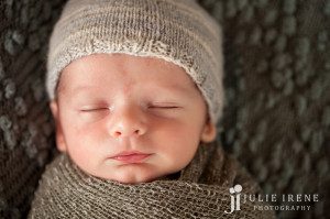 sweet newborn smile wrapped gray