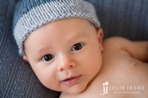 close up newborn baby boy knit blue hat