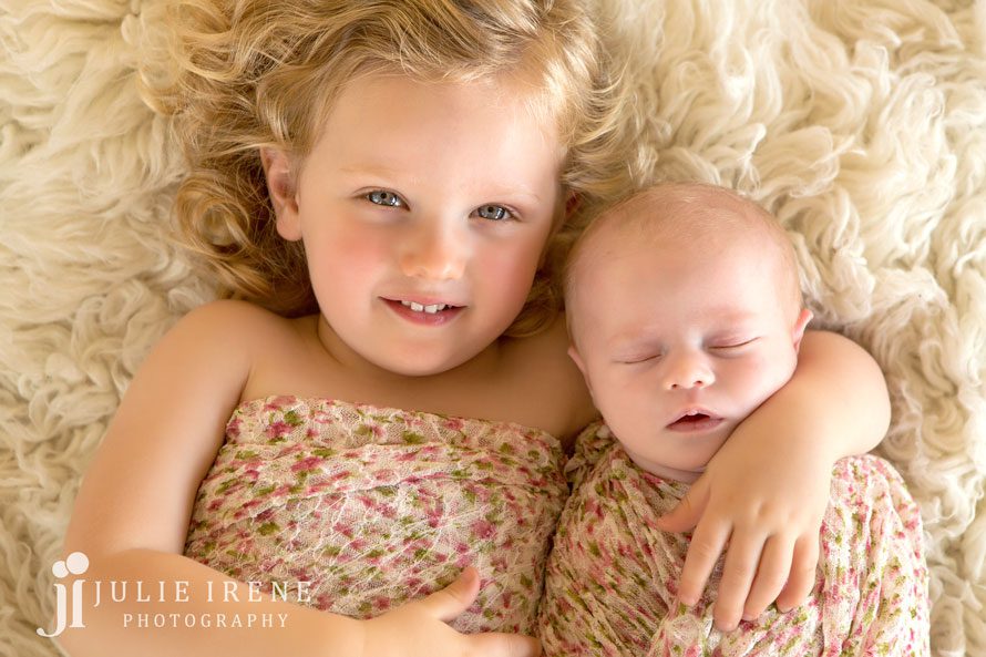sweet and serious sibling newborn girls photo