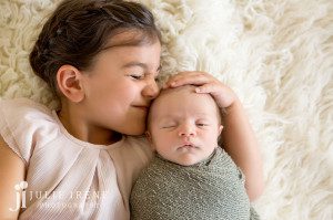 sister kiss newborn baby boy photo