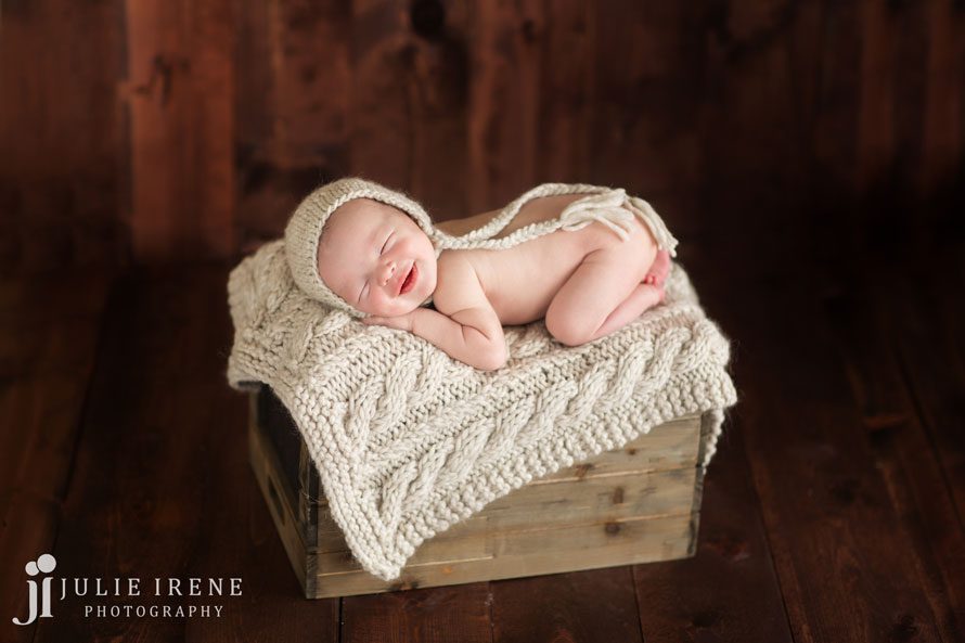 Newborn smile on a crate San Clemente