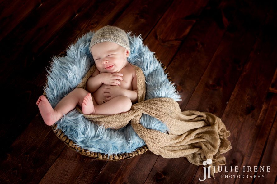 sweet smile in a basket blue newborn boy