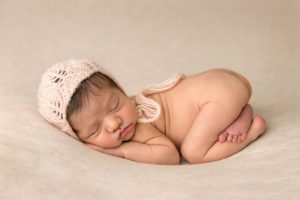 pink newborn girl with knit hat
