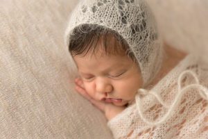 side angle newborn girl in wrapped knit