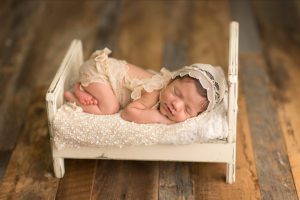 baby girl on cream bed with mia joy outfit