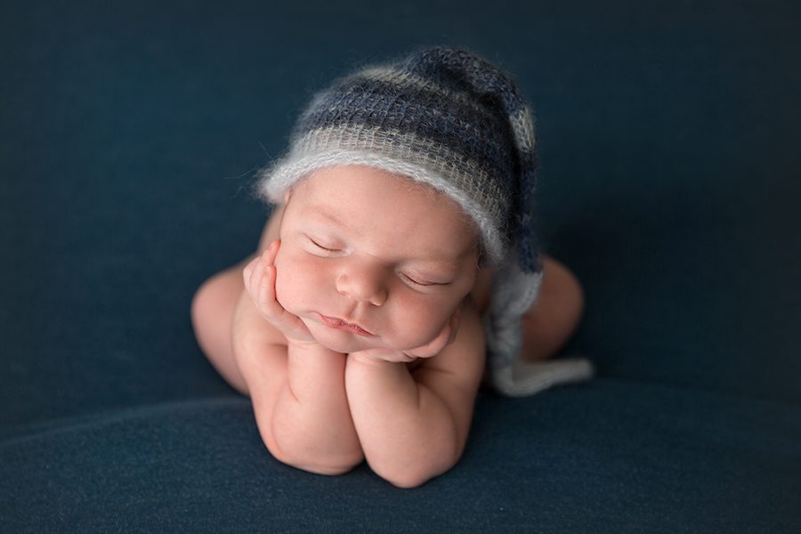 blue knit sleepy hat newborn boy froggy pose