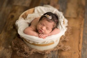 neutral newborn girl wood bucket burlap
