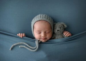 a little boy sleeping with his teddy