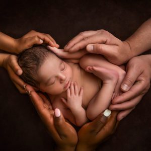 mixed race baby loved in the hands