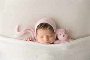 light pink teddy bear newborn girl portrait
