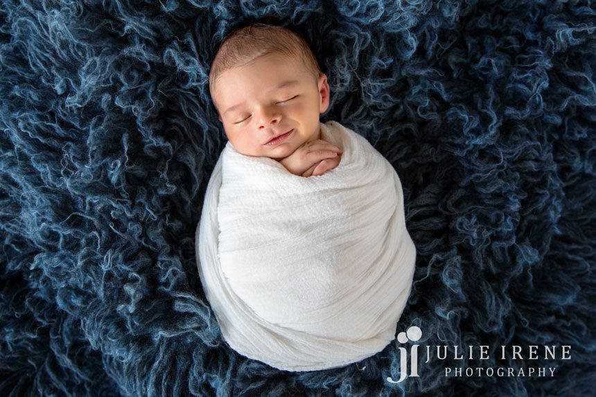 wrapped up newborn baby white photo