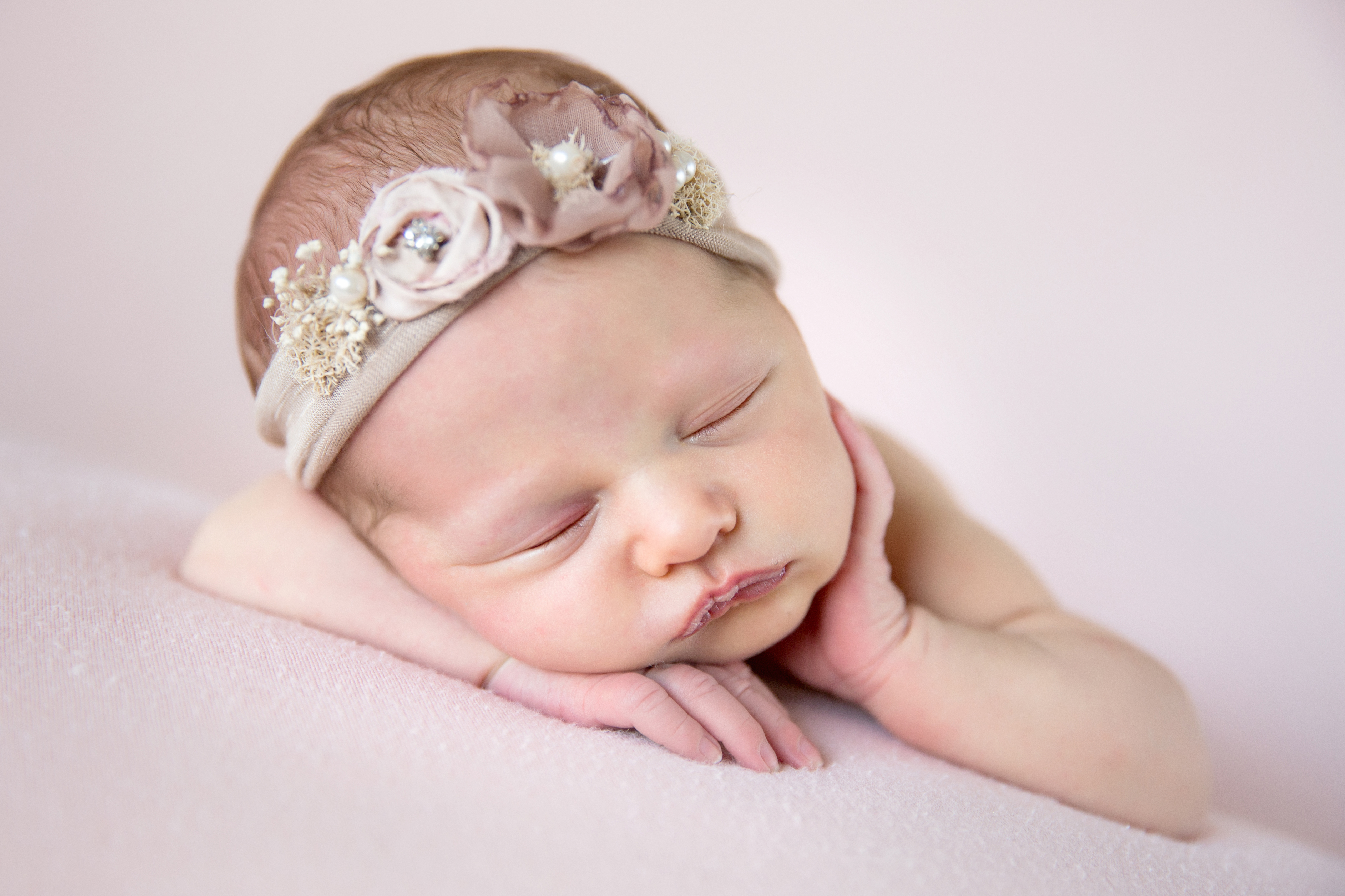 oc photographer newborn hand on cheek pink girl