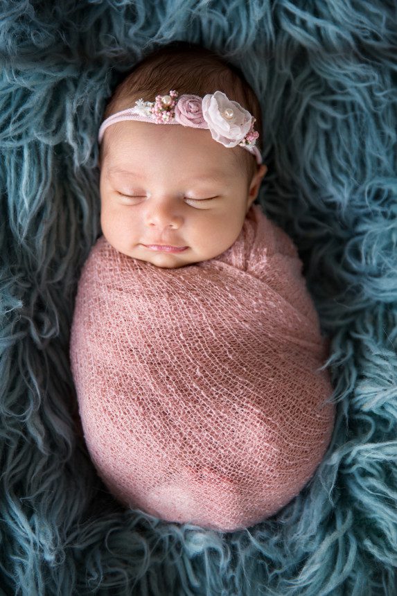 sweet smile swaddled in pink newborn baby photo