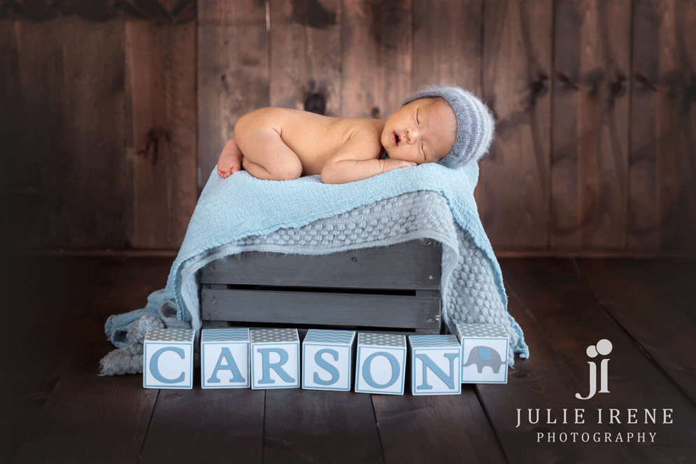 carson newborn boy on a crate