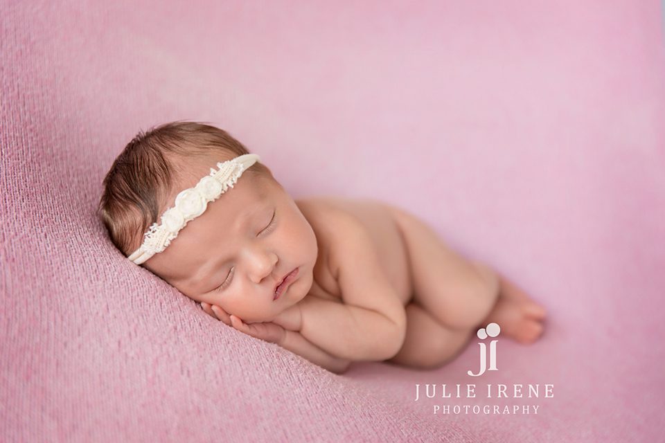 sweet newborn side laying pose in san clemente