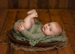 baby boy in green hand knit outfit