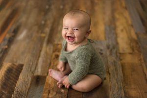 green hand knit outfit with baby boy smiles