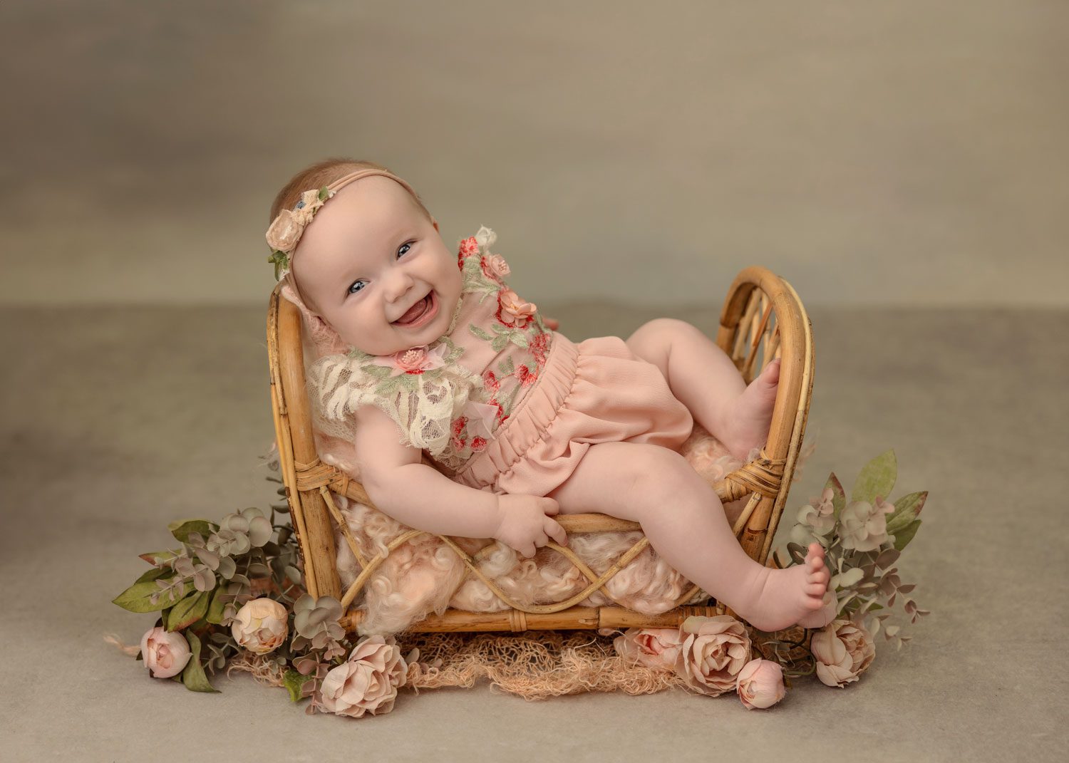 Baby sitting in a bed photography prop for a portrait session in San clemente