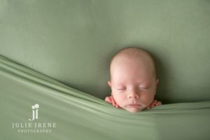 sleepy newborn pose in green