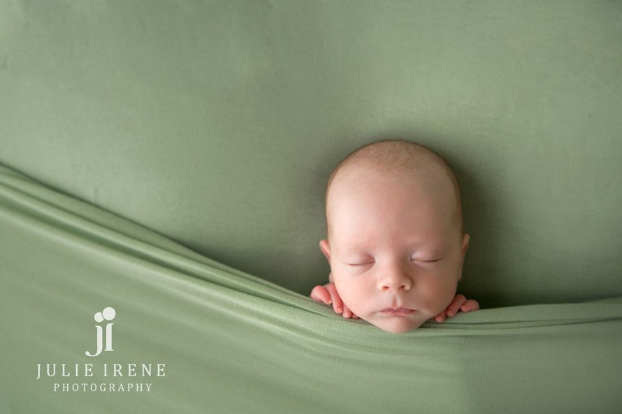 sleepy newborn pose in green