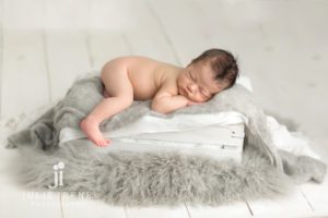 white and gray newborn baby crate photo