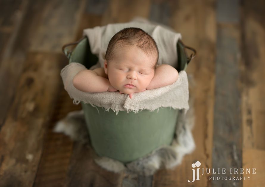 sage green bucket prop newborn baby photography