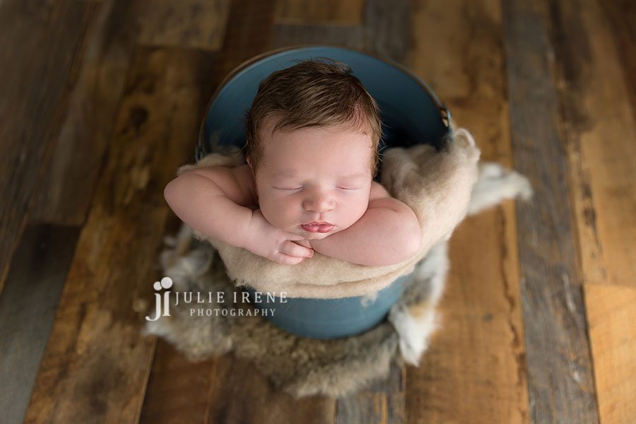 boy in blue bucket newborn photo