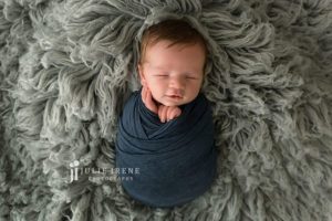wrapped newborn smiles