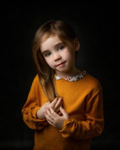 girl in a fine art portrait with dark background