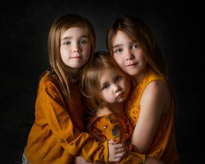 sibling sisters wearing yellow in a family photo