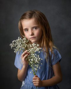 portrait of a girl holding baby's breath