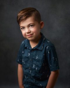 portrait of a 5 year old boy in blue