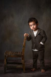 a little boy wearing a suit portrait