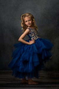 blonde girl in blue ball gown dress