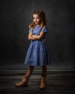 girl in a blue dress with cowboy boots