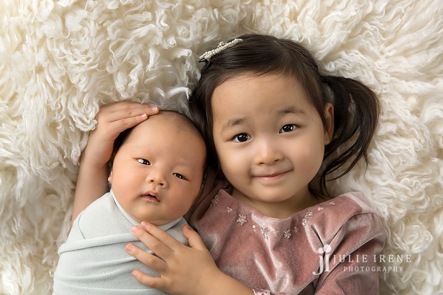 asian siblings during newborn session