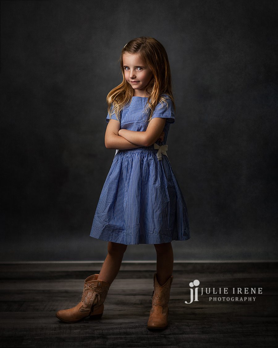 adorable girl in cowboy boots posing for a portrait