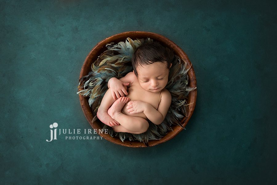 baby boy in feathers for newborn portraits