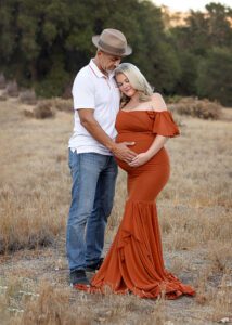 field couple maternity picture