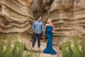 sandstone cliffs with husband and wife expecting baby