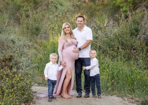 a pregnant mom with husband and boys