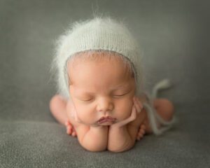 newborn boy with fuzzy knitted bonnet