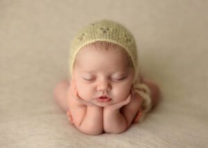 newborn with yellow bonnet