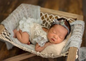 asian baby in blue in hammock